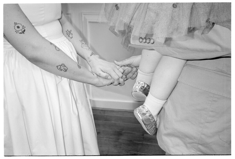 Close-up of the couple holding hands during their wedding ceremony