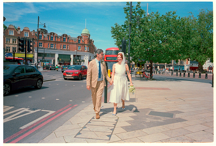 Bride and groom crossing the road after their registry office wedding